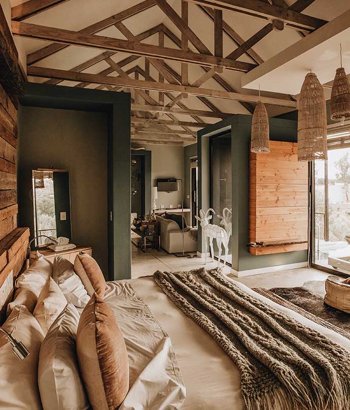 Suíte do The Olive Exclusive com decoração contemporânea inspirada em oliveiras.