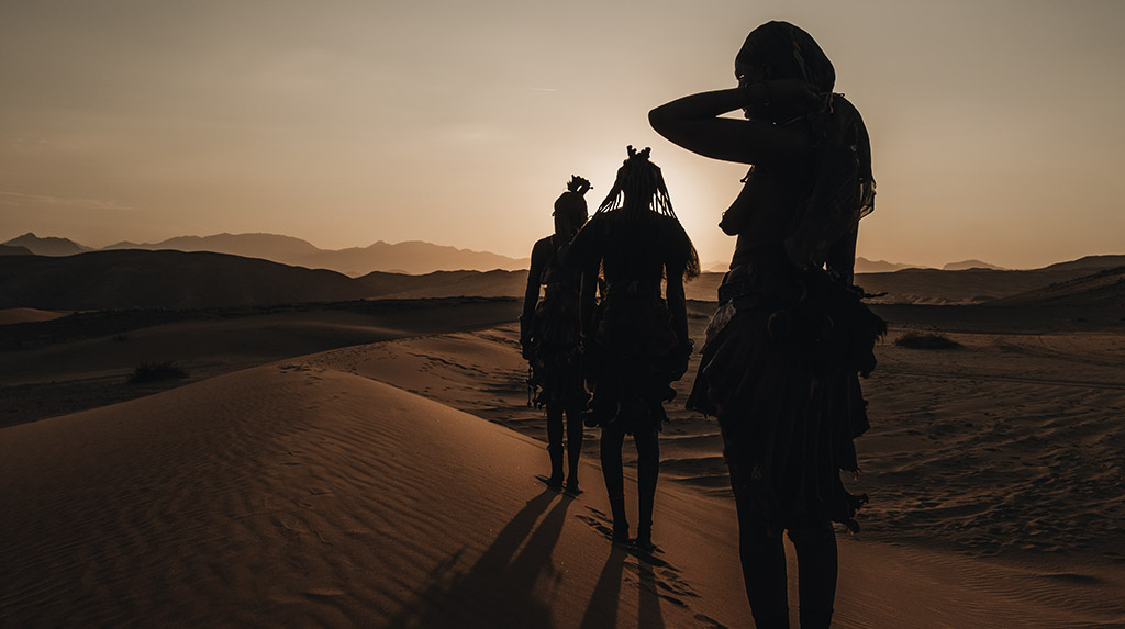 Mulheres Himba ao amanhecer, guardiãs de terras comunitárias no noroeste da Namíbia.